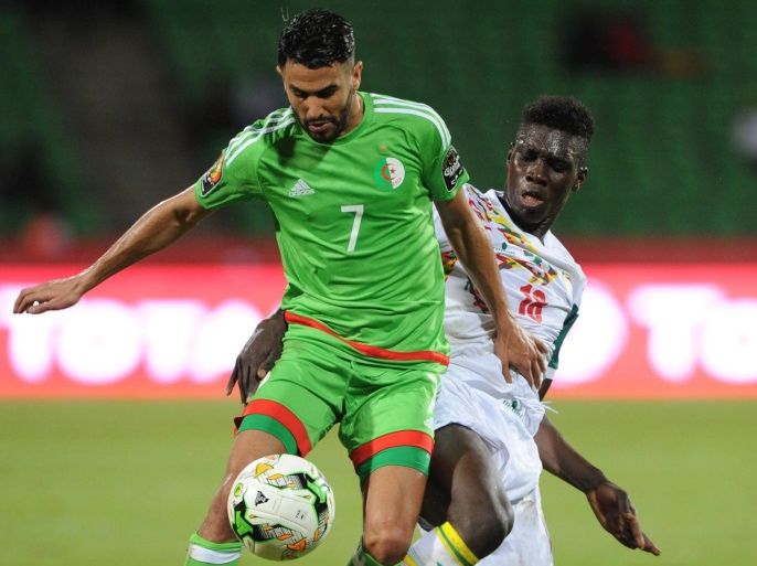 Riyad Mahrez of Algeria (l) is tackled by Ismaila Sarr of Senegal (r) during the African Coup of Nations Group B match between Senegal and Algeria at Franceville, Gabon, 23 January 2017.