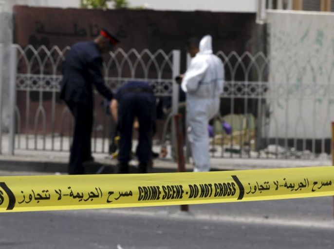 Explosives specialist police conduct their investigation after a bomb blast in the village of Sitra, south of Manama, Bahrain, July 28, 2015. The bomb attack killed two Bahraini policemen on duty in the mainly Shi'ite village of Sitra, south of the capital Manama, the Interior Ministry said on Tuesday, days after the government said it had disrupted an arms smuggling plot linked to Iran. REUTERS/Hamad I Mohammed