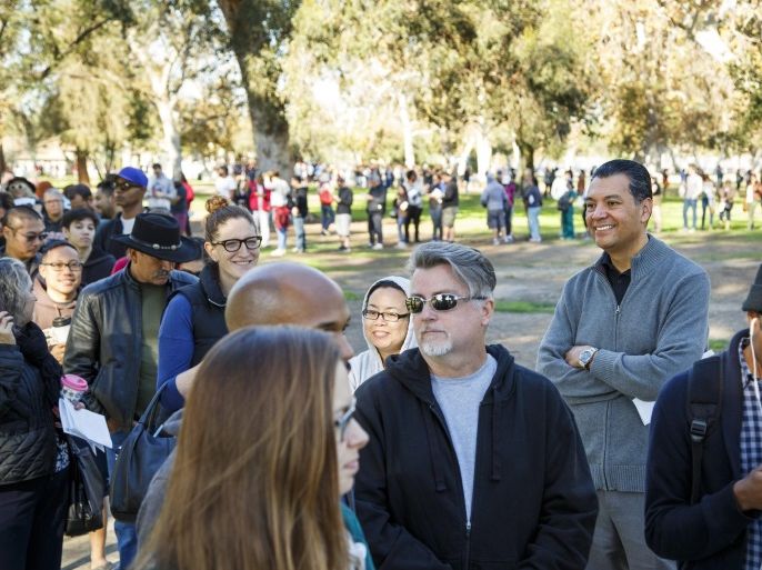 California Secretary of State Alex Padilla (2-R) wait with other voters in a line nearly four-hours long to cast their US Presidential ballots during weekend early voting at a polling place in North Hollywood, California, 05 November 2016. The general election is scheduled to take place 08 November 2016, but California allows early voting at select polling places in the weekends before. The Secretary of State's office is in charge of the voting process in California.