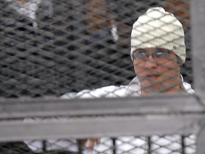 (FILE) A file photo dated 22 December 2013 shows Egyptian leader of opposition April 6 Youth Movement Ahmed Maher (R) and Egyptian activist Ahmed Douma (L) standing behind dock bars during their trial in Cairo, Egypt. A Cairo court on 07 April 2014 rejected an appeal by three Egyptian activists against a three-year jail sentence for holding an unauthorized demonstration. Ahmed Maher, founder of the April 6 Youth Movement which played a key role in the 2011 uprising aga