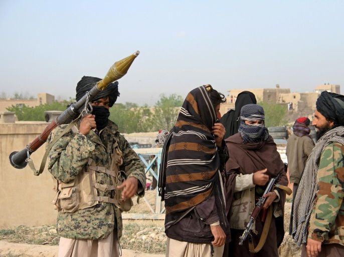 FILE PHOTO - Members of the Taliban gather at the site of the execution of three men accused of murdering a couple during a robbery in Ghazni province, Afghanistan April 18, 2015. REUTERS/Stringer/File Photo