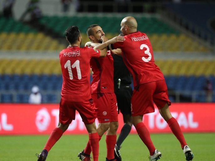 Sliti Naim of Tunisia celebrates goal (c) with teammates Aymen Abdennour (r) and Taha Yassine Khenissi (l) during the 2017 African Cup of Nations match between Zimbabwe and Tunisia at the Libreville Stadium in Gabon, 23 January 2017.