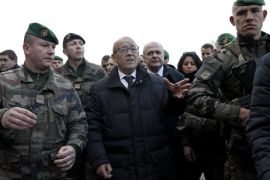 French Defense Minister Jean-Yves Le Drian (C) and French Interior Minister Bruno Le Roux (C-R) meet with French soldiers patrolling during 'Sentinelle' military operation, to discuss New Year holiday security measures in Paris, France, 30 December 2016. French authorities are stepping up security measures at various public areas over the Christmas holiday, after 12 people were killed and at least 48 injured when a truck ploughed into a busy Christmas market in Berlin