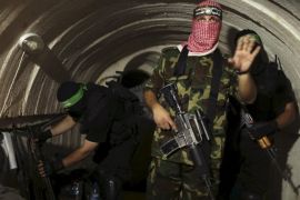 A Palestinian fighter from the Izz el-Deen al-Qassam Brigades, the armed wing of the Hamas movement, gestures inside an underground tunnel in Gaza in this August 18, 2014 file photo. REUTERS/Mohammed Salem/Files
