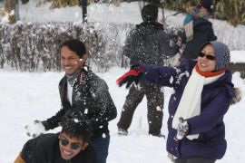 Malaysian tourists have a snowball fight at a village of traditional Korean houses on Seoul's Mount Nam, a tourist spot in the South Korean capital, 04 February 2013. South Korea's central region was hit by a heavy snowfall that started the previous afternoon, with Seoul recording 16.5 cm of snow.