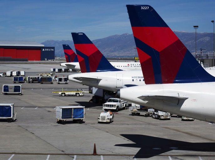 Delta planes line up at their gates while on the tarmac of Salt Lake City International Airport in Utah in this file photo taken September 28, 2013. Shares of Delta Air Lines Inc surged almost 5 percent in morning trading on Tuesday after it gave a healthy outlook for the first quarter despite a harsh winter that was expected to hurt airlines. REUTERS/Lucas Jackson/Files (UNITED STATES - Tags: TRANSPORT BUSINESS)