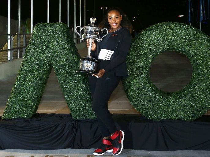 Tennis - Australian Open - Melbourne Park, Melbourne, Australia - early 29/1/17 Serena Williams of the U.S. poses with the Women's singles trophy after winning her final match. REUTERS/Thomas Peter