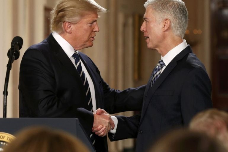 U.S. President Donald Trump shakes hands with Neil Gorsuch (R) after nominating him to be an associate justice of the U.S. Supreme Court at the White House in Washington, D.C., U.S., January 31, 2017. REUTERS/Kevin Lamarque