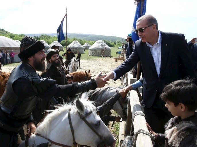 Turkish President Tayyip Erdogan (R) shakes hands with actors during a visit to the set of the TV series "Dirilis" in Istanbul, Turkey, in this June 7, 2015 handout photo provided by the Turkish Presidential Palace Press Office. Erdogan's hopes of assuming greater powers suffered a major setback on Sunday when the ruling AK Party he founded failed to win an outright majority in a parliamentary election for the first time. Erdogan, Turkey's most popular modern leader but also its most divisive, had hoped a crushing victory for the AKP would allow it to change the constitution and create a more powerful U.S.-style presidency. To do that, it would have needed to win two-thirds of the seats in parliament. Picture taken June 7, 2015. REUTERS/Yasin Bulbul/Presidential Palace Press Office/Handout via ReutersATTENTION EDITORS - THIS PICTURE WAS PROVIDED BY A THIRD PARTY. REUTERS IS UNABLE TO INDEPENDENTLY VERIFY THE AUTHENTICITY, CONTENT, LOCATION OR DATE OF THIS IMAGE. THIS PICTURE IS DISTRIBUTED EXACTLY AS RECEIVED BY REUTERS, AS A SERVICE TO CLIENTS. FOR EDITORIAL USE ONLY. NOT FOR SALE FOR MARKETING OR ADVERTISING CAMPAIGNS. NO ARCHIVES. NO SALES. NO COMMERCIAL USE.