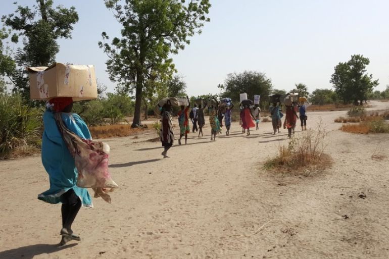 A handout photo made available on 21 February 2017 by Doctors without Borders (MSF) shows a team leaving Dablual where they had the first mobile clinic to go to Rieri, South Sudan, 12 February 2017. They sometimes have to walk for long hours so they hire people from the local community to help them carrying the supply. Some of them used to work at MSF hospital before it was shut down after several lootings. Several United Nations agencies warned that some 100,000 people