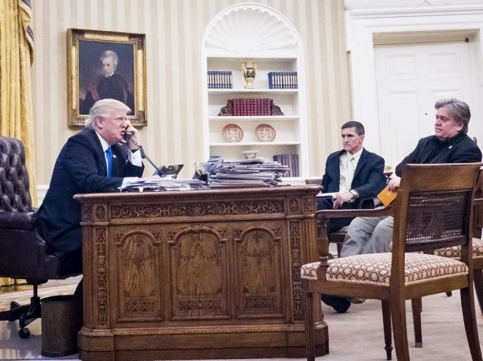 National Security Advisor Michael Flynn (C) and Senior Counselor to the President Steve Bannon (R), sit nearby as US President Donald J. Trump (L) speaks on the phone with Prime Minister of Australia, Malcolm Turnbull in the Oval Office in Washington, DC, USA, 28 January 2017. The call was one of five calls with foreign leaders scheduled for 28 January.