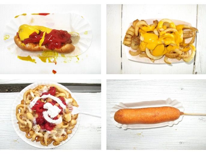 (10/30) A combo image made from four separate photographs shows carnival food that fairgoers purchased at the Delaware County Fair in Manchester Iowa, USA, 11 July 2013. They are (clockwise from upper left): a hot dog with ketchup and mustard, curly fries with cheese, a fried corn dog, and a funnel cake with strawberry topping and whip cream. Every summer, each of Iowa's 99 counties throws its own fair. Provincial and patriotic, with beauty pageants and demolition derb