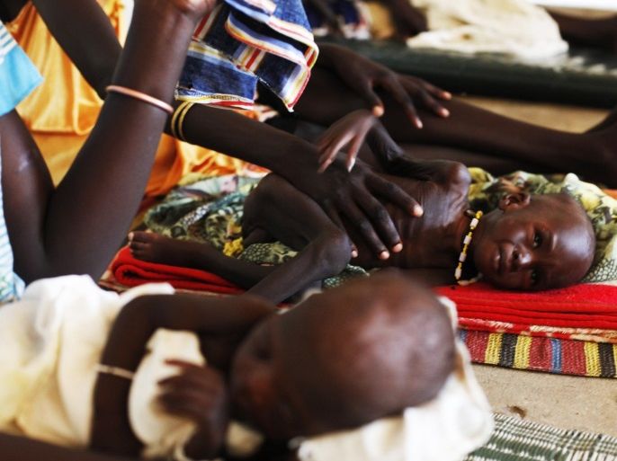 Malnourished children lay next to their mothers at the Medecins Sans Frontieres (MSF) hospital in Leer July 15, 2014. The MSF hospital was giving service to over 200,000 people before it was looted and burned during fighting in late January and early February. The Hospital currently attends 1400 malnourished children according to Medecins Sans Frontieres. REUTERS/Andreea Campeanu (SOUTH SUDAN - Tags: HEALTH POLITICS SOCIETY FOOD)