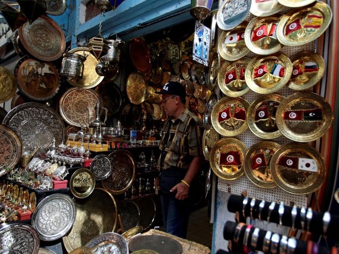 A tourist looks at traditional souvenirs displayed for sale in the old city of Tunis, Tunisia June 17, 2016. REUTERS/Zoubeir Souissi