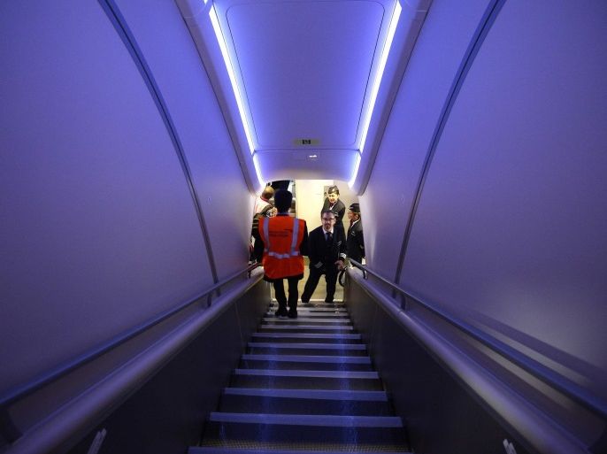 Staff use the stairs between the upper and lower decks of the British Airways Airbus A380 at Heathrow Airport in London July 4, 2013. British Airways received its first Airbus A380 jet at Heathrow airport on Thursday, marking the start of modernising its aging fleet with new, more fuel-efficient planes able to better compete with fast-growing rivals. REUTERS/Paul Hackett (BRITAIN - Tags: BUSINESS TRANSPORT TRAVEL)