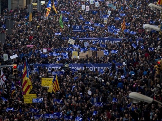 Thousands of people march under the slogan 'Stop excuses. Let's take in now', during a demonstration organized by entities supporting the campaign 'Casa Nostra, Casa Vostra' (lit: Our Home, Your Home), to call for the reception of migrants and refugees in Barcelona, northeastern Spain, 18 February 2017.