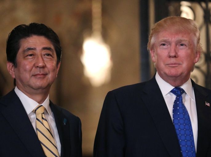 Japanese Prime Minister Shinzo Abe and U.S. President Donald Trump pose for a photograph before attending dinner at Mar-a-Lago Club in Palm Beach, Florida, U.S., February 11, 2017. REUTERS/Carlos Barria