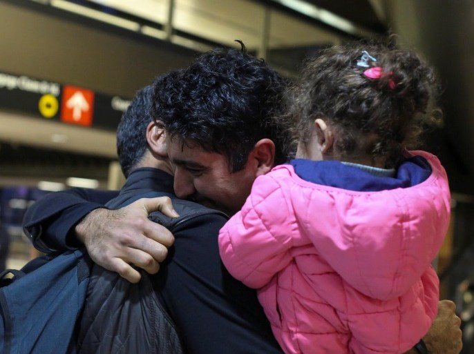 Iranian citizen and U.S green card holder Cyrus Khosravi (C) greets his brother, Hamidreza Khosravi (L), and niece, Dena Khosravi (R), 2, after they were detained for additional screening following their arrival to Seattle-Tacoma International Airport to visit Cyrus, during a pause in U.S. President Donald Trump's travel ban in SeaTac, Washington, U.S. February 6, 2017. REUTERS/David Ryder