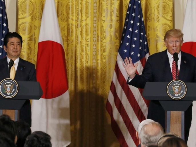 Japanese Prime Minister Shinzo Abe (L) looks on as U.S. President Donald Trump speaks during a joint press conference at the White House in Washington, U.S., February 10, 2017. REUTERS/Jim Bourg