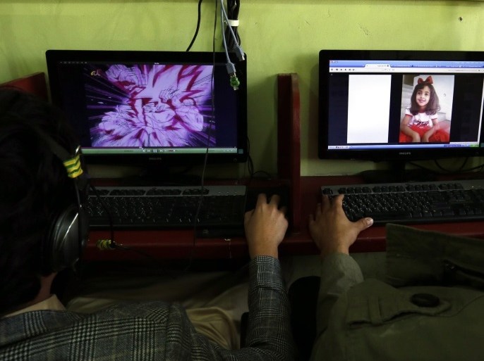 A Yemeni man looks at the picture of an alleged victim, 8-year-old Yemeni girl Anwar al-Awlaki, of the recent US raid in central Yemen, as another watches an anime show at a cafe in Sana'a, Yemen, 30 January 2017. According to reports, elite US forces launched on 29 January a dawn raid against suspected al-Qaeda militants in central Yemen, killing 41 militants and 16 civilians-eight women and eight children, including the eight-year-old daughter, Anwar al-Awlaki of US-