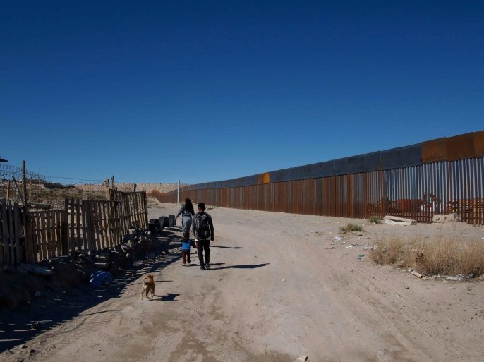 People walk in front of the border fence between Anapra, in Ciudad Juarez, Mexico, and the US states of Texas and New Mexico, 26 January 2017. Mexican President Enrique Peña Nieto cancelled his proposed trip to the USA, on 26 January due to President Donald J. Trump's insistence on building a wall on the USA/Mexico border, and his claims that 'Mexico will pay for the wall.' On 25 January, President Trump signed an executive order to begin 'immediate construction' o