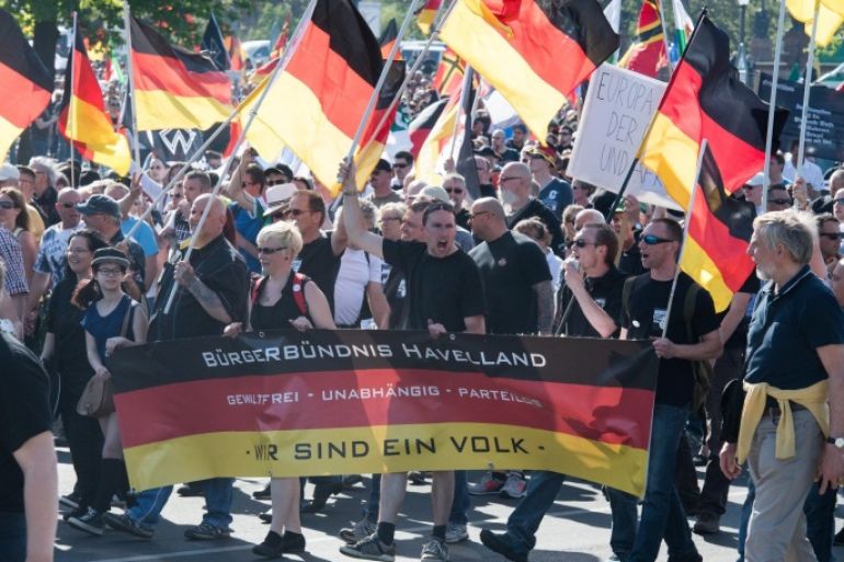 Participants in a march of right-wing groups walk past the Federal Chancellery and carry a banner written with 'Citizen's Alliance Havelland - non-violent, independent, partyless - We are one people' in Berlin, Germany, 07 May 2016. The right-wing populist movement 'Wir fuer Berlin &amp; Wir fuer Deutschland' (We for Berlin &amp; We for Germany) called for a demonstration with the slogan 'Merkel must go.' Multiple alliances of citizens' and left-wing groups and parties