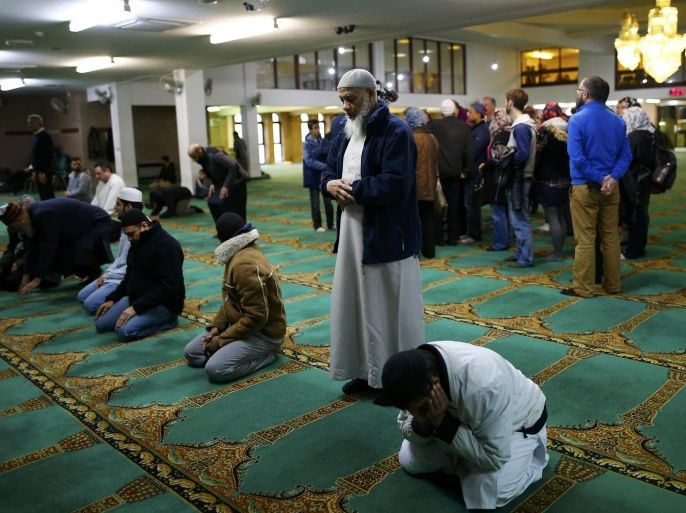 Men pray as visitors are given a tour of the Birmingham Central Mosque, on visit my mosque day in Birmingham, Britain February 7, 2016. REUTERS/Darren Staples