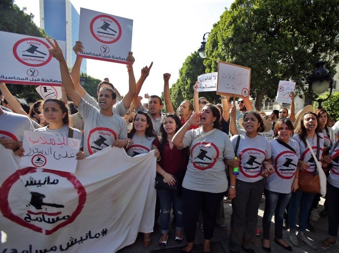 Young Tunisian protesters take part in a rally called by the opposition against the economic reconciliation bill, in Tunis, Tunisia, 12 September 2015. According to local reports the draft economic and financial reconciliation law submitted by the Tunisian President, Beji Caid Essebsi, has divided Tunisians, with a majority concerned that pardoning corrupt officials from the previous regime will encourage graft and lose Tunisia millions in stolen money, however the majo