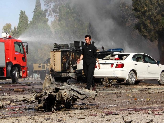 Afghan security officials inspect the scene of a suicide bomb attack that targeted an Afghan Army vehicle in Lashkar Gah, Helmand province, Afghanistan, 11 February 2017. At least 11 people were killed and 20 people injured in the incident.