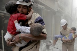 FILE PHOTO - Members of the Civil Defence rescue children after what activists said was an air strike by forces loyal to Syria's President Bashar al-Assad in al-Shaar neighbourhood of Aleppo, Syria June 2, 2014. REUTERS/Sultan Kitaz/File Photo