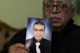 Reda Abdullah al-Hamamy, the father of Abdullah Reda al-Hamamy who is suspected of attacking a soldier in Paris' Louvre museum, holds a picture of his son during an interview with Reuters in Daqahliya, Egypt, February 4, 2017. REUTERS/Mohamed Abd El Ghany FOR EDITORIAL USE ONLY. NO RESALES. NO ARCHIVES