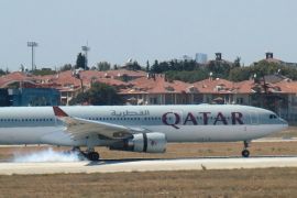 A Qatar Airways aircraft is seen after making an emergency landing at Ataturk International Airport in Istanbul, Turkey, August 18, 2016. The smoke seen at the aircraft's wheels is due to its landing. REUTERS/Stringer FOR EDITORIAL USE ONLY. NO RESALES. NO ARCHIVES.