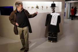 French anthropologist Denis Vidal looks at the Berenson robot during the exhibition "Persona : Oddly Human" at the Quai Branly museum in Paris, France, February 23, 2016. The Berenson robot, developed in France in 2011, is the brainchild of anthropologist Denis Vidal and robotics engineer Philippe Gaussier. Its programming allows it to record reactions of museum visitors to certain pieces of art and then use the data to develop its own unique taste, which allows "Berens