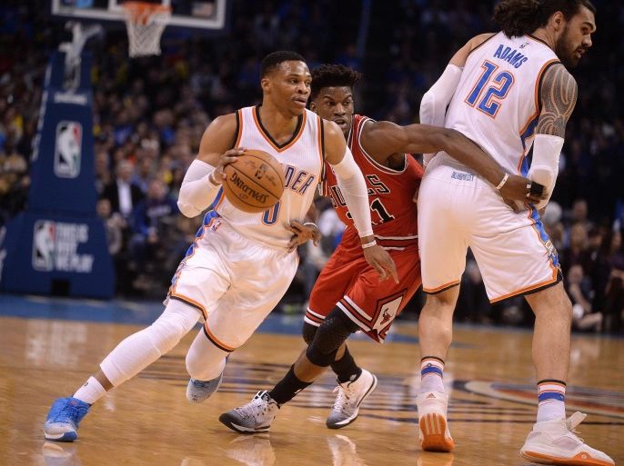 Feb 1, 2017; Oklahoma City, OK, USA; Oklahoma City Thunder guard Russell Westbrook (0) drives to the basket defended by Chicago Bulls forward Jimmy Butler (21) behind a screen set by Oklahoma City Thunder center Steven Adams (12) during the first quarter at Chesapeake Energy Arena. Mandatory Credit: Mark D. Smith-USA TODAY Sports