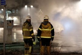 Firefighters are seen as several cars were set on fire during a riot, according to local media, in Rinkeby suburb, outside Stockholm, Sweden February 21, 2017. TT News Agency/Christine Olsson/via REUTERS ATTENTION EDITORS - THIS IMAGE WAS PROVIDED BY A THIRD PARTY. FOR EDITORIAL USE ONLY. SWEDEN OUT. NO COMMERCIAL OR EDITORIAL SALES IN SWEDEN.