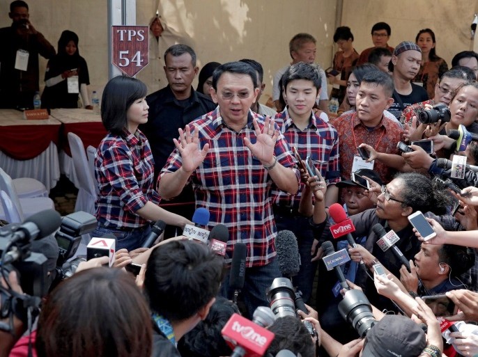 Governor of Indonesia's capital Basuki Tjahaja Purnama talks to reporters after casting his ballot during an election for Jakarta's governor in Jakarta, Indonesia, February 15, 2017. REUTERS/Beawiharta