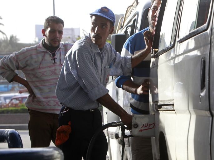 A worker fills the tank of a car at a petrol station in Cairo, March 12, 2013. Egypt's oil minister Osama Kamal has dismissed the head of state-owned Misr Petroleum and another top official due to a crisis in distributing fuel used by buses and trucks, state news agency MENA said. Picture taken March 12, 2013. REUTERS/Mohamed Abd El Ghany (EGYPT - Tags: POLITICS BUSINESS COMMODITIES)