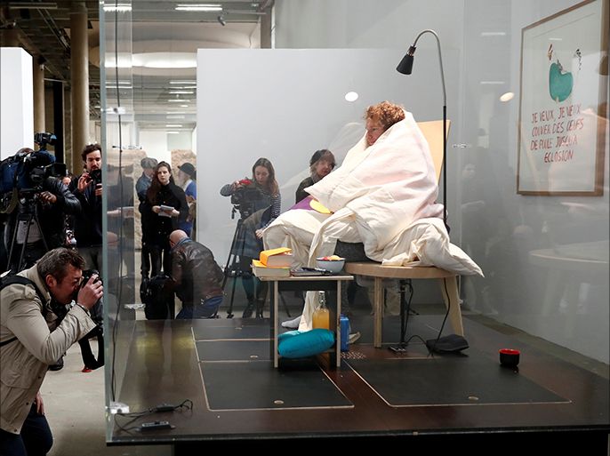 French artist Abraham Poincheval is seen in a vivarium on the first day of his performance in an attempt to incubate chicken eggs, which takes from 21 to 26 days, at the Palais de Tokyo Museum in Paris