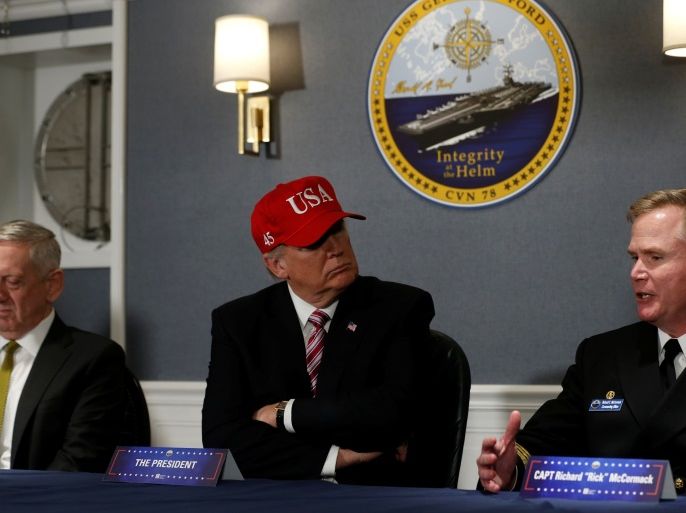 U.S. President Donald Trump (C, in red hat) and Defense Secretary James Mattis (L) receive a briefing with Commanding Officer U.S. Navy Captain Rick McCormack (R) aboard the pre-commissioned U.S. Navy aircraft carrier Gerald R. Ford at Huntington Ingalls Newport News Shipbuilding facilities in Newport News, Virginia, U.S. March 2, 2017. REUTERS/Jonathan Ernst