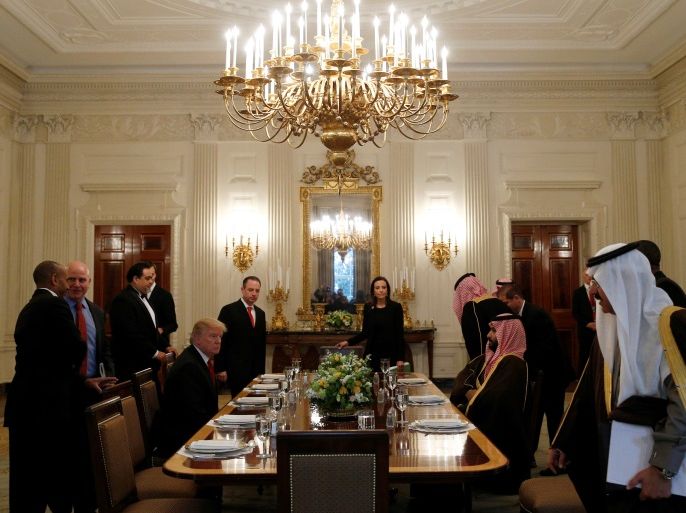 U.S. President Donald Trump and Saudi Deputy Crown Prince and Minister of Defense Mohammed bin Salman take their seats for lunch in the State Dining Room of the White House in Washington, U.S., March 14, 2017. REUTERS/Kevin Lamarque