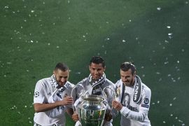 MADRID, SPAIN - MAY 29: Cristiano Ronaldo (2ndL) of Real Madrid CF holds the trophy as he poses for a picture with his teammates Karim Benzema (L) and Gareth Bale (R) during the celebration with their fans at Santiago Bernabeu Stadium the day after winning the UEFA Champions League Final match against Club Atletico de Madrid on May 29, 2016 in Madrid, Spain. Real Madrid CF is the only European football team with 11 European Cups (Photo by Gonzalo Arroyo Moreno/Getty Images)