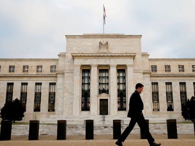 FILE PHOTO: A man walks past the Federal Reserve Bank in Washington, D.C., U.S. December 16, 2015. REUTERS/Kevin Lamarque/File Photo GLOBAL BUSINESS WEEK AHEAD PACKAGE Ð SEARCH BUSINESS WEEK AHEAD MARCH 13 FOR ALL IMAGES