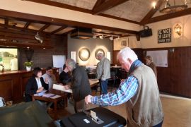 People vote in a bar used as a polling station in Ankeveen, Netherlands, March 15, 2017. REUTERS/Toussaint Kluiters