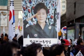 Supporters of South Korean President Park Geun-hye holding national flag Taegeukgi attend a protest called
