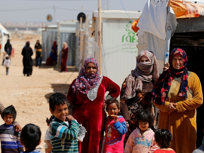 Syrian refugees stand during the visit of United Nations Secretary General Antonio Guterres to Al Zaatari refugee camp in the Jordanian city of Mafraq, near the border with Syria March 28, 2017. REUTERS/Ammar Awad