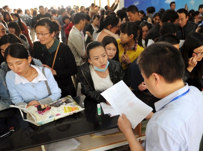 People line up to apply for teaching jobs at the local education bureau, in Lianyungang, Jiangsu province, China, May 6, 2015. REUTERS/China Daily CHINA OUT. NO COMMERCIAL OR EDITORIAL SALES IN CHINA