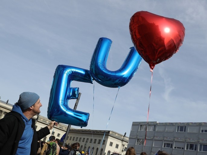 BERLIN, GERMANY - MARCH 25: A man holds balloons shaped inthe letters 'E' and 'U' for the European Union and a heart at a 'March for Europe' gathering to celebrate the 60th anniversary of the Treaty of Rome, which created the precursor to the European Union, on March 25, 2017 in Berlin, Germany. Cities across Europe are holding celebrations and the main event, with politicians from across the EU, is taking place in Rome. (Photo by Sean Gallup/Getty Images)