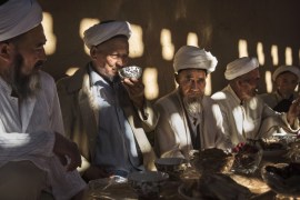 TURPAN, CHINA - SEPTEMBER 13: (CHINA OUT) Uyghur men gather for a holiday meal during the Corban Festival on September 13, 2016 in Turpan County, in the far western Xinjiang province, China. The Corban festival, known to Muslims worldwide as Eid al-Adha or 'feast of the sacrifice', is celebrated by ethnic Uyghurs across Xinjiang, the far-western region of China bordering Central Asia that is home to roughly half of the country's 23 million Muslims. The festival, considered the most important of the year, involves religious rites and visits to the graves of relatives, as well as sharing meals with family. Although Islam is a 'recognized' religion in the constitution of officially atheist China, ethnic Uyghurs are subjected to restrictions on religious and cultural practices that are imposed by China's Communist Party. Ethnic tensions have fueled violence that Chinese authorities point to as justification for the restrictions. (Photo by Kevin Frayer/Getty Images)