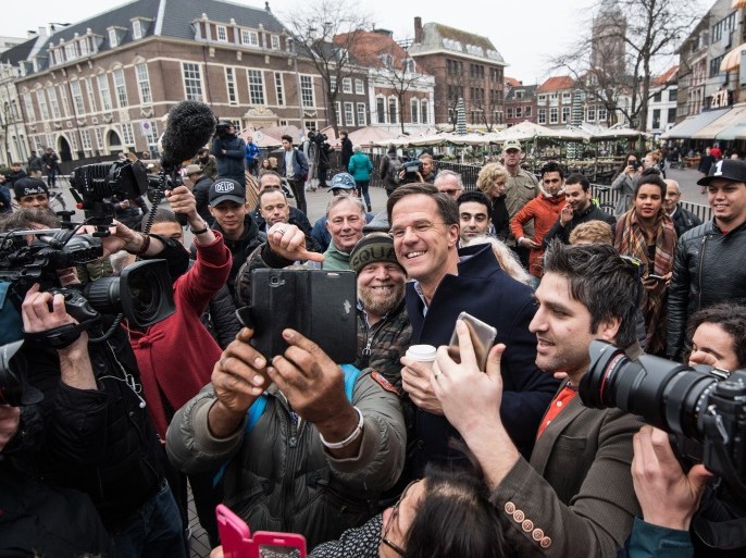 THE HAGUE, NETHERLANDS - MARCH 14: Dutch Prime Minister Mark Rutte takes a selfie photograph with supporters as he campaigns ahead of tomorrow's general election, on March 14, 2017 in The Hague, Netherlands. Campaigning is continuing by all parties ahead of tomorrow's general election in which the right-wing Party for Freedom (PVV), led by Geert Wilders, is expected to do well. (Photo by Carl Court/Getty Images)