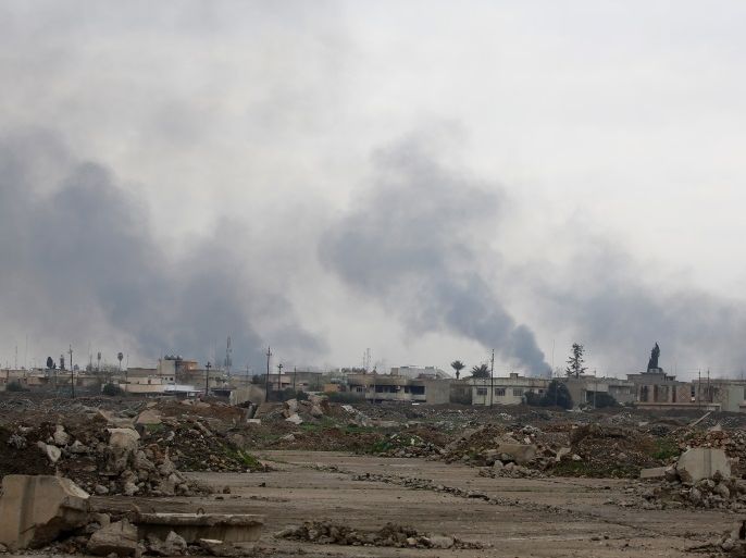 Smoke rises from clashes during a battle between Iraqi forces and Islamic State militants, as seen from Mosul Airport which is being ran by Iraqi forces, in the city of Mosul, Iraq, March 15, 2017. REUTERS/Youssef Boudlal